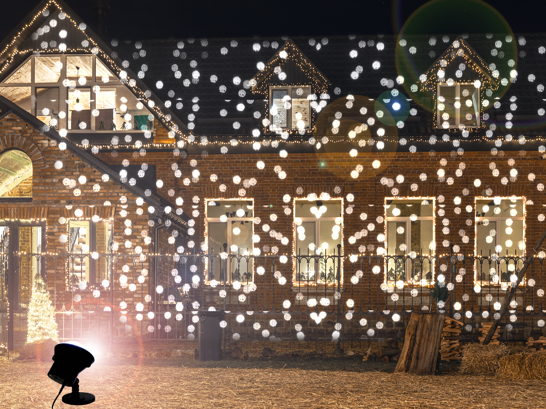 A projector on a house lighting it up with a snowflake effect